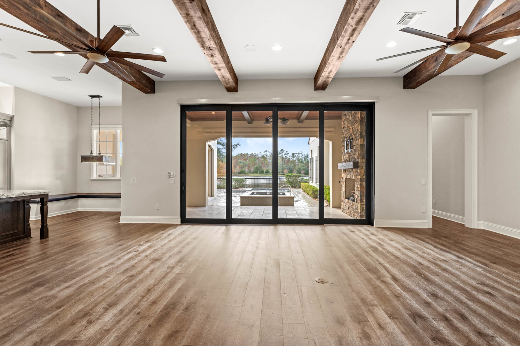 living room with large glass windows to back patio